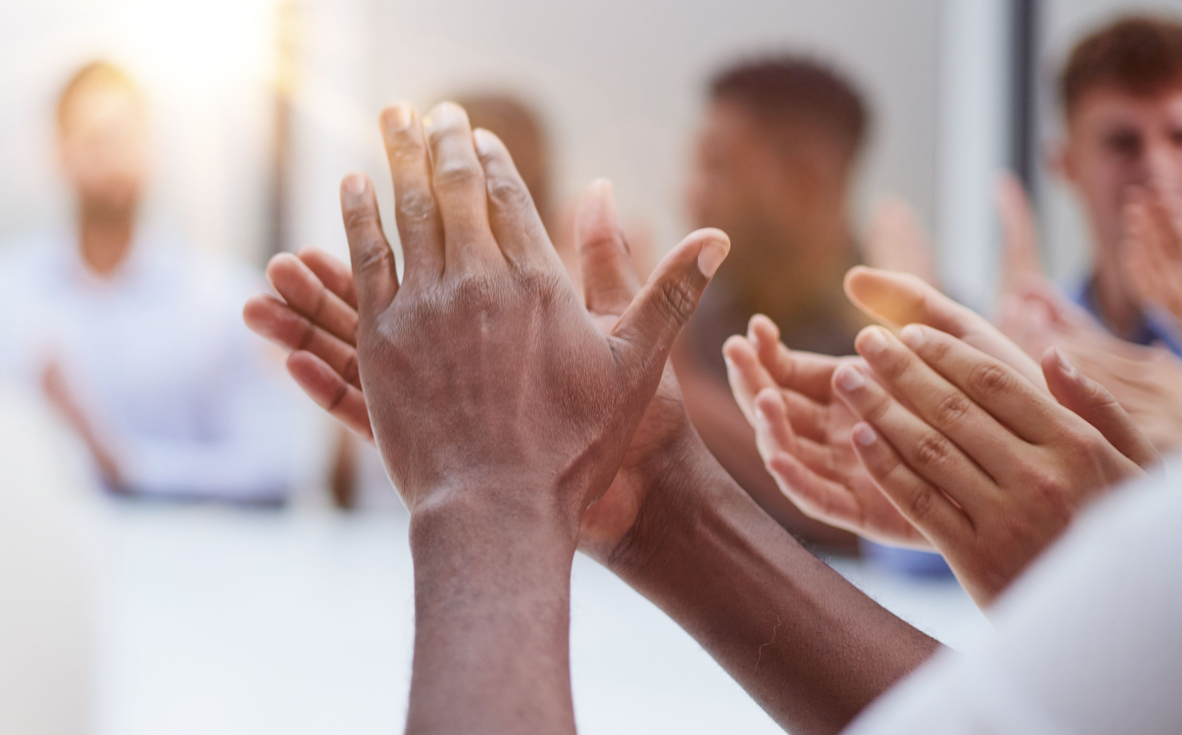 A couple of women standing next to each other with laptops